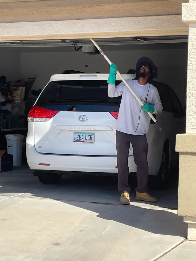LMS Pest Solutions working around a garage entrance